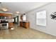 Well-lit kitchen featuring wood cabinets, stainless steel appliances and adjacent dining area at 888 Streamside Dr, Greenfield, IN 46140