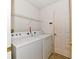 Functional laundry room with washer, dryer, and ample storage space at 888 Streamside Dr, Greenfield, IN 46140
