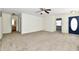 Spacious living room featuring neutral carpet, ceiling fan, and an adjacent bathroom at 888 Streamside Dr, Greenfield, IN 46140