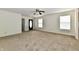 Spacious living room featuring neutral carpet, ceiling fan, and a blue front door at 888 Streamside Dr, Greenfield, IN 46140