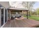 Back deck featuring covered patio furniture and playset in the grassy backyard at 9011 Harrison Run Dr, Indianapolis, IN 46256