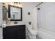 Stylish bathroom featuring black vanity with sink, modern toilet, and subway tile in shower at 9011 Harrison Run Dr, Indianapolis, IN 46256