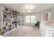 Bright bedroom featuring a wall of bookshelves, a cozy chair, and a comfortable bed at 9011 Harrison Run Dr, Indianapolis, IN 46256