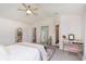 Spacious bedroom with large mirror, plush carpet, ceiling fan and natural light at 9011 Harrison Run Dr, Indianapolis, IN 46256