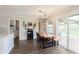 Bright dining area features modern light fixture and sliding glass doors to the deck and backyard at 9011 Harrison Run Dr, Indianapolis, IN 46256