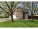 Charming two-story home featuring a well-maintained lawn and mature trees, creating a serene setting at 9011 Harrison Run Dr, Indianapolis, IN 46256