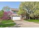 Beautiful home with a spacious driveway, attached garage, and vibrant landscaping for curb appeal at 9011 Harrison Run Dr, Indianapolis, IN 46256