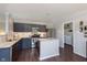 Modern kitchen with stainless steel appliances, an island, and sleek navy blue cabinets at 9011 Harrison Run Dr, Indianapolis, IN 46256