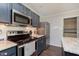 Well-equipped kitchen boasts stainless steel appliances, granite countertops, subway tile backsplash and modern cabinets at 9011 Harrison Run Dr, Indianapolis, IN 46256
