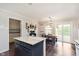 Open kitchen with island, granite countertops, modern cabinets, and stainless steel appliances with adjoining eat-in kitchen at 9011 Harrison Run Dr, Indianapolis, IN 46256