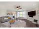 Open living room with modern decor, ceiling fan, fireplace, and ample natural light at 9011 Harrison Run Dr, Indianapolis, IN 46256