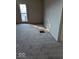 Empty bedroom featuring neutral carpet, white walls, a radiator and a view of the neighborhood through the window at 9278 S Geneva Rd, Flat Rock, IN 47234