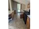 Long kitchen with dated cabinets and countertops, a black range, and an exterior entrance at the back at 9278 S Geneva Rd, Flat Rock, IN 47234