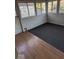Enclosed sun room with wood and vinyl flooring, bead board paneling and windows overlooking the backyard at 9278 S Geneva Rd, Flat Rock, IN 47234