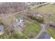 Aerial view of home nestled among mature trees with a long gravel driveway at 9531 Prospect St, Indianapolis, IN 46239