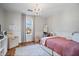Bedroom with a charming chandelier, natural light, and decorative area rug at 9531 Prospect St, Indianapolis, IN 46239