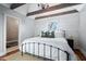 Charming bedroom with exposed wood beams, hardwood floors and comfortable decor at 9531 Prospect St, Indianapolis, IN 46239