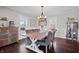 Formal dining room with a large wooden table, stylish chairs, and abundant natural light at 9531 Prospect St, Indianapolis, IN 46239