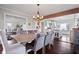 Spacious dining room featuring an elegant chandelier and access to the living room and kitchen at 9531 Prospect St, Indianapolis, IN 46239