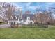 Exterior view of home with a large manicured lawn, privacy fence, and mature trees at 9531 Prospect St, Indianapolis, IN 46239