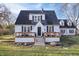 Charming home features a front porch, black door, and dormer windows at 9531 Prospect St, Indianapolis, IN 46239