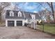 Charming two-story home with black two-car garage and a black iron fence at 9531 Prospect St, Indianapolis, IN 46239