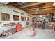 Large, spacious garage with wood beams, red tool chest, and various equipment at 9531 Prospect St, Indianapolis, IN 46239