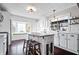 Modern kitchen with white cabinetry, butcher block island, and large windows offering ample natural light at 9531 Prospect St, Indianapolis, IN 46239