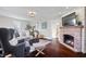Cozy living room with a brick fireplace and hardwood floors, perfect for relaxation at 9531 Prospect St, Indianapolis, IN 46239