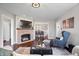 Elegant living room with a fireplace, hardwood floors, and open access to the dining area at 9531 Prospect St, Indianapolis, IN 46239