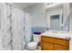 The full bathroom features a marbled sink with wood cabinets and a shower/tub combo at 1012 Balto Dr, Shelbyville, IN 46176