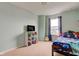 Bright bedroom with a full-sized bed, window, and a display shelf, creating a peaceful atmosphere at 1012 Balto Dr, Shelbyville, IN 46176