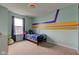 Bright bedroom with a full-sized bed, window, and colorful design, creating a peaceful atmosphere at 1012 Balto Dr, Shelbyville, IN 46176