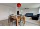 Cozy dining area with a wooden table, stylish light fixture, and view into the living room at 1012 Balto Dr, Shelbyville, IN 46176