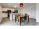 Bright dining room with wood table, stylish red light fixture, and views to the kitchen and doorway at 1012 Balto Dr, Shelbyville, IN 46176