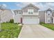 Charming two-story home with a two-car garage, a red front door, and a well-manicured lawn at 1012 Balto Dr, Shelbyville, IN 46176