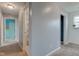 Hallway with neutral walls and carpet, providing access to bedrooms and bathrooms at 1012 Balto Dr, Shelbyville, IN 46176