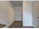 Bright hallway featuring modern flooring, a white front door, and neutral wall paint at 1012 Balto Dr, Shelbyville, IN 46176