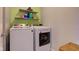 Laundry room with two newer model white washing machines and storage shelves at 1012 Balto Dr, Shelbyville, IN 46176