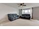 Spacious living room featuring plush sofas, a ceiling fan, and lots of natural light at 1012 Balto Dr, Shelbyville, IN 46176