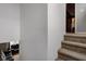 Carpeted staircase leading to the upper level, open to the living area with lots of natural light at 1012 Balto Dr, Shelbyville, IN 46176