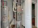 Utility room with hot water tank and furnace in an alcove with an access door at 1012 Balto Dr, Shelbyville, IN 46176