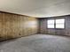 Expansive Den offers paneled walls, carpeted floors and natural light through the window at 10131 Nassau Ln, Indianapolis, IN 46229