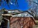 Close view captures the home's brick and siding exterior under a bright blue sky at 10131 Nassau Ln, Indianapolis, IN 46229