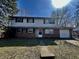 Charming two-story home featuring a brick facade, attached garage, and a sunny front lawn at 10131 Nassau Ln, Indianapolis, IN 46229
