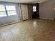 Spacious living room with natural light, neutral paint, and staircase to the second floor at 10131 Nassau Ln, Indianapolis, IN 46229
