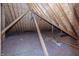 View of unfinished attic featuring exposed wooden beams and plywood subflooring at 10415 Charter Oaks, Carmel, IN 46032