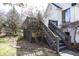 A cozy back stairway leads to the upper levels of the charming white brick home at 10415 Charter Oaks, Carmel, IN 46032