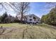 A well-manicured backyard with a fire pit, water feature, and lush landscaping at 10415 Charter Oaks, Carmel, IN 46032