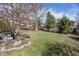 An elevated view of backyard showing lush greenery, trees, and firepit at 10415 Charter Oaks, Carmel, IN 46032